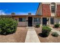 Townhome with well-manicured landscaping and a unique stone facade for added curb appeal at 3912 Palos Verdes St, Las Vegas, NV 89119