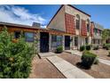 Attractive townhome with stone accents, a red tile roof, and mature landscaping at 3912 Palos Verdes St, Las Vegas, NV 89119