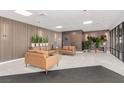 Relaxing lobby with modern seating, plants, light tile flooring, wood slat wall and recessed lighting at 3930 University Center Dr # 208, Las Vegas, NV 89119