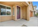 Covered front porch featuring beige siding and an oval glass front door at 4078 Blue Manor Ln, North Las Vegas, NV 89032