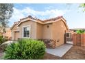 Side view of a single-story home with stone accents and mature landscaping at 4329 Skimmers Ct, North Las Vegas, NV 89084