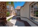 View of side yard featuring decorative rock and walkway to back yard at 4481 Faberge Ave, Las Vegas, NV 89115