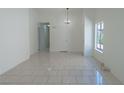 Open floor plan featuring tile flooring, neutral walls, large window, and bright open space at 4481 Faberge Ave, Las Vegas, NV 89115