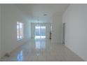 Bright living room with tile flooring, neutral walls, and ample natural light from the sliding glass door at 4481 Faberge Ave, Las Vegas, NV 89115