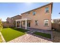 Backyard features artificial turf and pavers, plus a pergola creating an outdoor living space at 528 Sunny Pointe St, Henderson, NV 89011