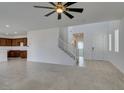 Open-concept living space with tile flooring and staircase, creating a seamless flow throughout the home at 528 Sunny Pointe St, Henderson, NV 89011