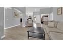 Bright living room features wood-look flooring, neutral paint, and seamless flow at 5433 Escallonia St, Las Vegas, NV 89149