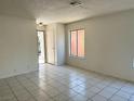 Bright living room with clean tile flooring, neutral walls, and an open layout at 5436 Burkshire Dr, Las Vegas, NV 89142