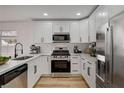 Modern white kitchen with stainless steel appliances, sleek countertops, and ample cabinet space at 5466 Silverheart Ave, Las Vegas, NV 89142
