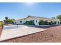 Spacious exterior with potential pickleball court and mature landscaping at 6419 Eldora Ave, Las Vegas, NV 89146