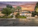 Beautiful home featuring manicured lawn, palm trees, decorative stone walkway and two car garage at 764 Ricota Ct, Henderson, NV 89012