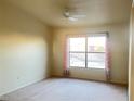 Cozy bedroom with carpet floors, ceiling fan and a window with curtains at 8000 Badura Ave # 2009, Las Vegas, NV 89113