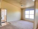 Spacious living room with large window and neutral carpeting at 8000 Badura Ave # 2009, Las Vegas, NV 89113