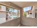 Balcony view of the community pool, surrounded by lush landscaping and palm trees providing a relaxing atmosphere at 829 Rock Springs Dr # 201, Las Vegas, NV 89128