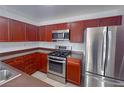 Kitchen showcases stainless steel appliances and attractive wood cabinetry at 9148 Alluring Ave, Las Vegas, NV 89149