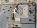 An aerial view of the property shows desert landscaping, a spacious lot and a well-maintained tile roof at 961 Laguna St, Pahrump, NV 89048