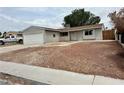 Classic single-story home featuring an attached garage and drought-resistant front yard at 1004 Stone River Dr, North Las Vegas, NV 89030