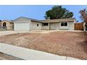 Charming home with a two-car garage and minimal landscaping, perfect for easy maintenance and care at 1004 Stone River Dr, North Las Vegas, NV 89030