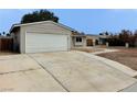 Home featuring a spacious two-car garage and a low-maintenance front yard at 1004 Stone River Dr, North Las Vegas, NV 89030