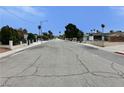 Street view showcasing a quiet residential neighborhood with tree-lined streets and single-Gathering homes at 1004 Stone River Dr, North Las Vegas, NV 89030
