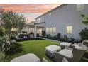 Luxurious backyard with manicured lawn, patio seating, covered outdoor kitchen perfect for relaxing or entertaining at 10196 Sequoia Glen Ave, Las Vegas, NV 89166