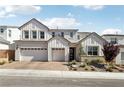 Beautiful two-story home featuring a brick driveway, three-car garage, modern design and well-manicured landscaping at 10196 Sequoia Glen Ave, Las Vegas, NV 89166