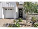 Inviting front entrance with a brick driveway, well-maintained landscaping, and charming front door at 10196 Sequoia Glen Ave, Las Vegas, NV 89166