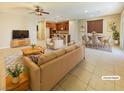 Open-concept living and dining area with neutral décor and tile floors, perfect for entertaining at 10331 Northern Hills Ave, Las Vegas, NV 89166