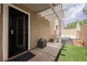 Cozy patio with a seating area, artificial turf, and shade covering, ideal for relaxation and outdoor living at 10400 Beautiful Fruit St, Las Vegas, NV 89183
