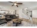 Spacious living room features wood floors, recessed lighting, stairs, and a ceiling fan at 10565 Olinda St, Las Vegas, NV 89179