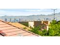 Scenic view of the city skyline with mountains in the background, seen from a residential rooftop at 10823 Drake Ridge Ave, Las Vegas, NV 89166