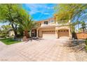 Beautiful two-story home with manicured lawn, mature trees, and a spacious three-car garage at 11237 Campsie Fells Ct, Las Vegas, NV 89141
