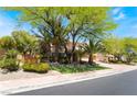 Charming home featuring mature trees, desert landscaping, and a well-manicured lawn at 11237 Campsie Fells Ct, Las Vegas, NV 89141