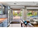 Living room with french doors opening to the patio and a view to the outdoor space at 11578 Suburban Rd, Las Vegas, NV 89135