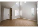 Bright, open living room with high ceilings, multiple windows, and tile flooring at 11900 Calle De Sol Dr, Las Vegas, NV 89138