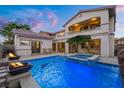 A beautiful backyard pool with a spa, patio seating, and fire bowls offers a relaxing outdoor experience at 12219 Crystal Shore Ave, Las Vegas, NV 89138