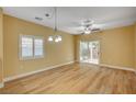 Bright dining area featuring hardwood floor, window with shutters, and sliding glass doors to the backyard at 1435 Orange Jubilee Rd, Henderson, NV 89014