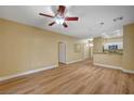 A spacious living room and dining area featuring hardwood floor, recessed lighting, and breakfast bar to the kitchen at 1435 Orange Jubilee Rd, Henderson, NV 89014