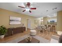 A spacious living room and dining area featuring hardwood floor, recessed lighting, and breakfast bar to the kitchen at 1435 Orange Jubilee Rd, Henderson, NV 89014