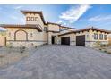 Beautiful exterior of a luxury home with stone accents, a red tile roof, and a three-car garage at 19 Rue Grimaldi Way, Henderson, NV 89011
