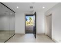 Bright foyer with large windows, light tile flooring, and a modern front door, offering an inviting entrance at 19 Rue Grimaldi Way, Henderson, NV 89011