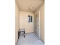 Exterior entryway features a security gate and small window, providing a secure welcome to the residence at 1900 Mountain Hills Ct # 203, Las Vegas, NV 89128