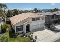 Aerial view of a stucco home featuring a tile roof, desert landscaping, and an attached two-car garage at 222 Hollyfern St, Henderson, NV 89074