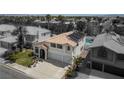 Aerial shot of home with solar panels, an in-ground pool, desert landscaping, and a two-car garage at 222 Hollyfern St, Henderson, NV 89074