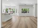 Open-concept living area featuring hardwood floors and plenty of natural light, seamlessly flowing into the kitchen at 2579 Ivoryhill St, Las Vegas, NV 89135