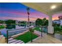 Picturesque balcony view overlooking a tranquil lake with lush greenery and mountains in the distance at 2589 Sun Reef Rd, Las Vegas, NV 89128