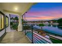 Scenic balcony view of a serene lake, swimming pool, mature palm trees, and luxury homes at 2589 Sun Reef Rd, Las Vegas, NV 89128