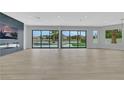 Spacious living room with wood floors, a modern fireplace, and expansive sliding glass doors to the backyard at 2589 Sun Reef Rd, Las Vegas, NV 89128