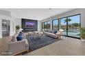 Spacious living room with modern furniture, fireplace, and large windows overlooking the pool at 2589 Sun Reef Rd, Las Vegas, NV 89128