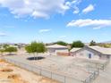 Expansive aerial view of the property showcasing the layout of the home, garage, and fenced yard at 2650 Sagebrush Ave, Pahrump, NV 89048